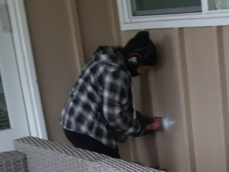 Professional electrician installing an exterior outlet in Rawlins
